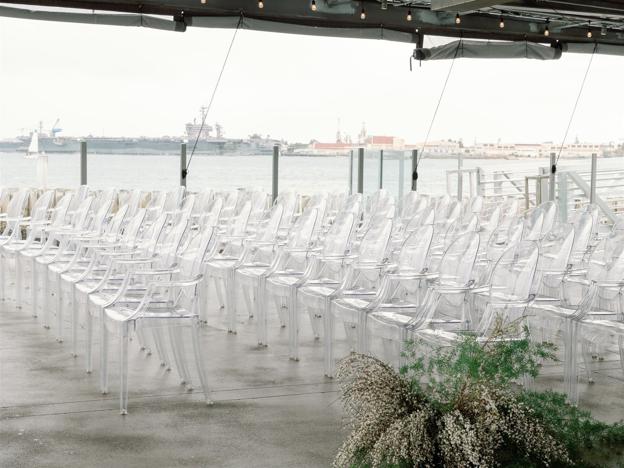 Wedding ceremony set up with acrylic ghost chairs at Coasterra
