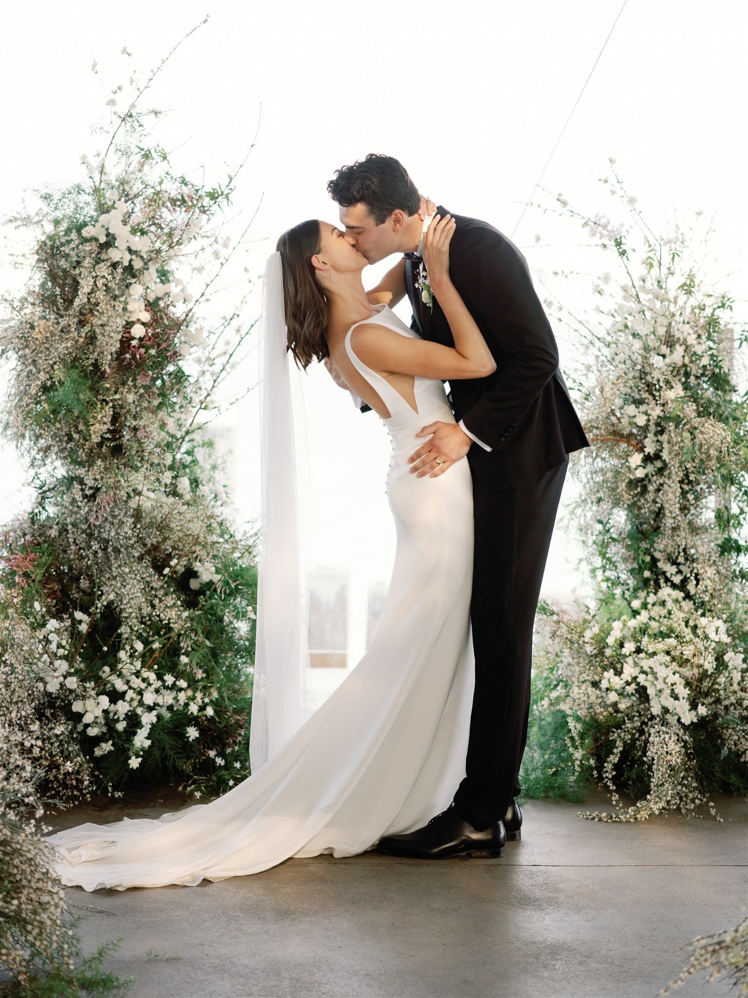 Bride and groom kissing at wedding ceremony
