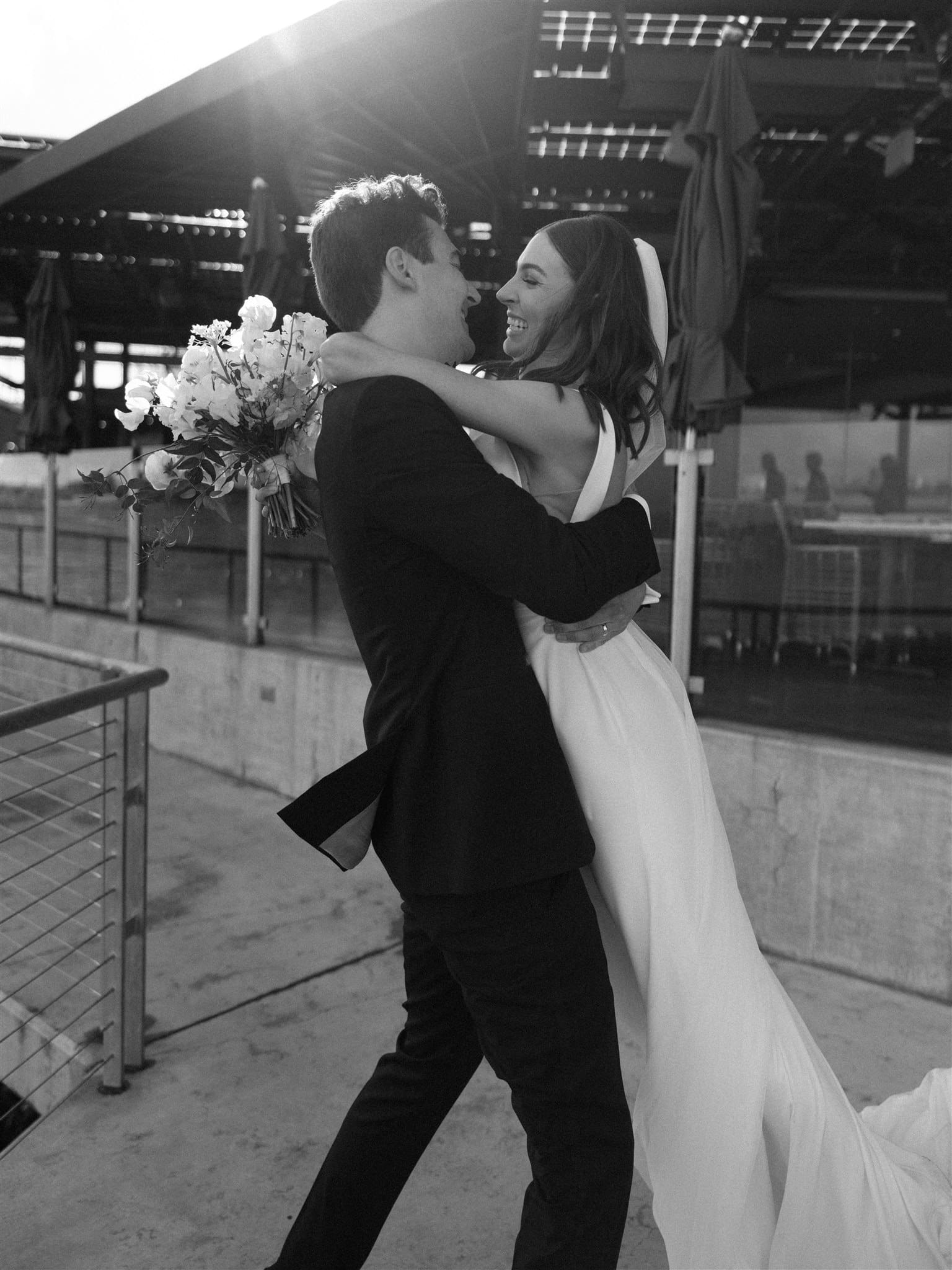 Bride and groom embracing after wedding ceremony at Coasterra