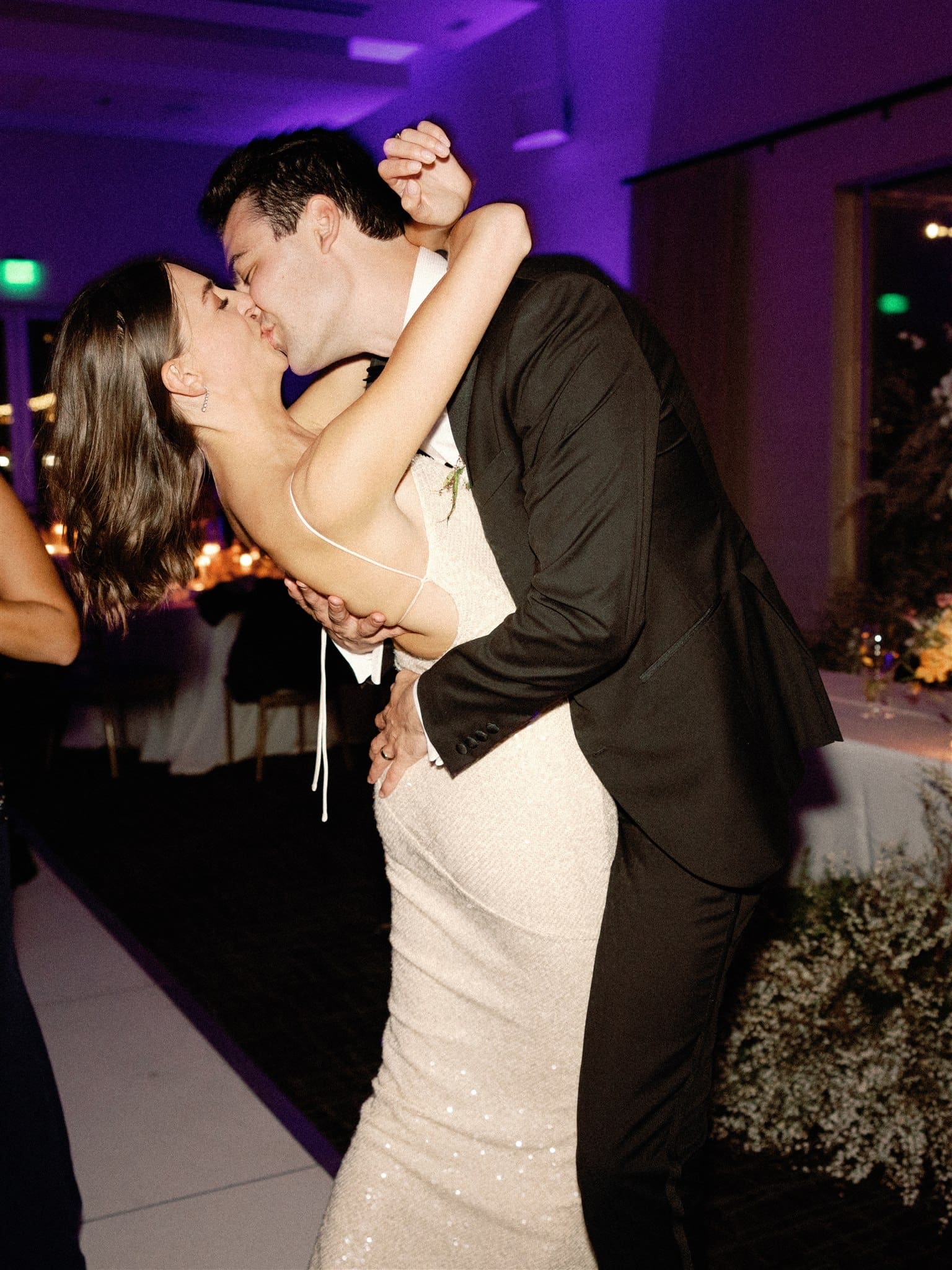 Bride and groom kissing at wedding reception