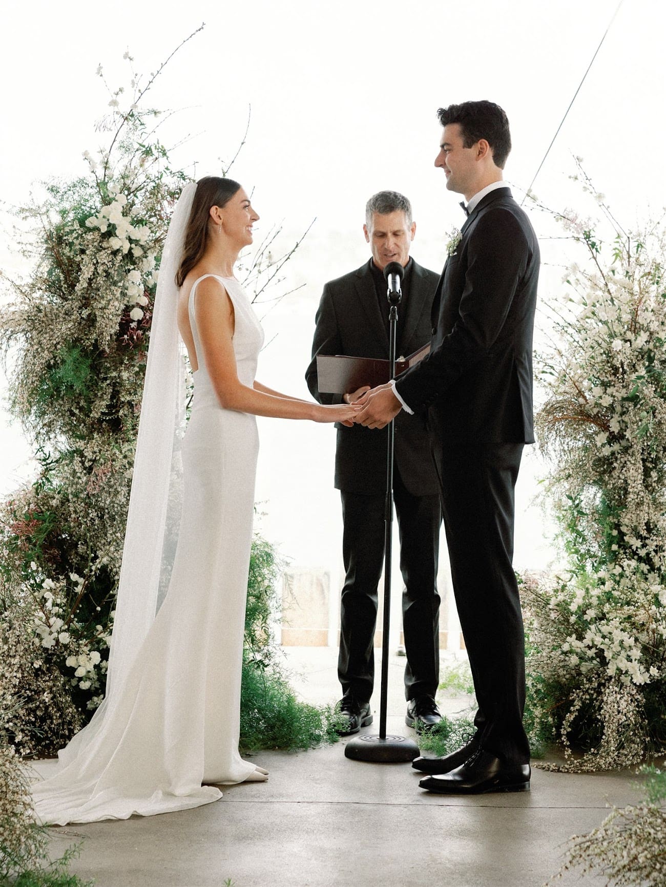 Bride and groom holding hands at wedding ceremony