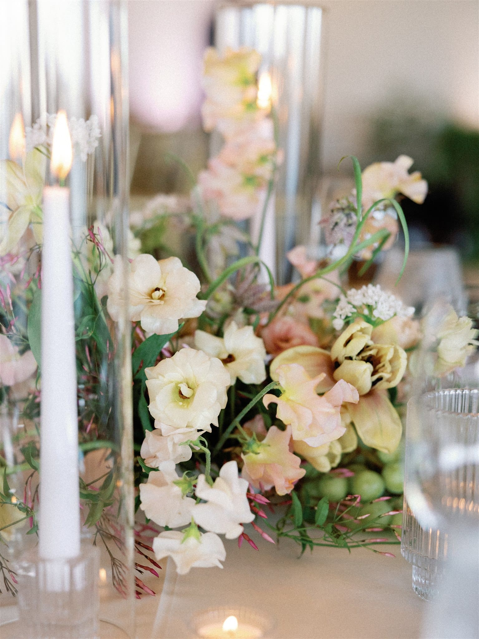 Wedding reception tablescape. with candles and white and pink florals
