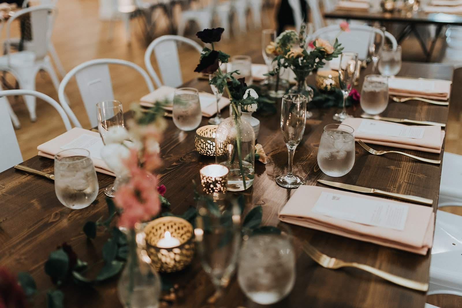 Wedding reception tablescape with candles and florals