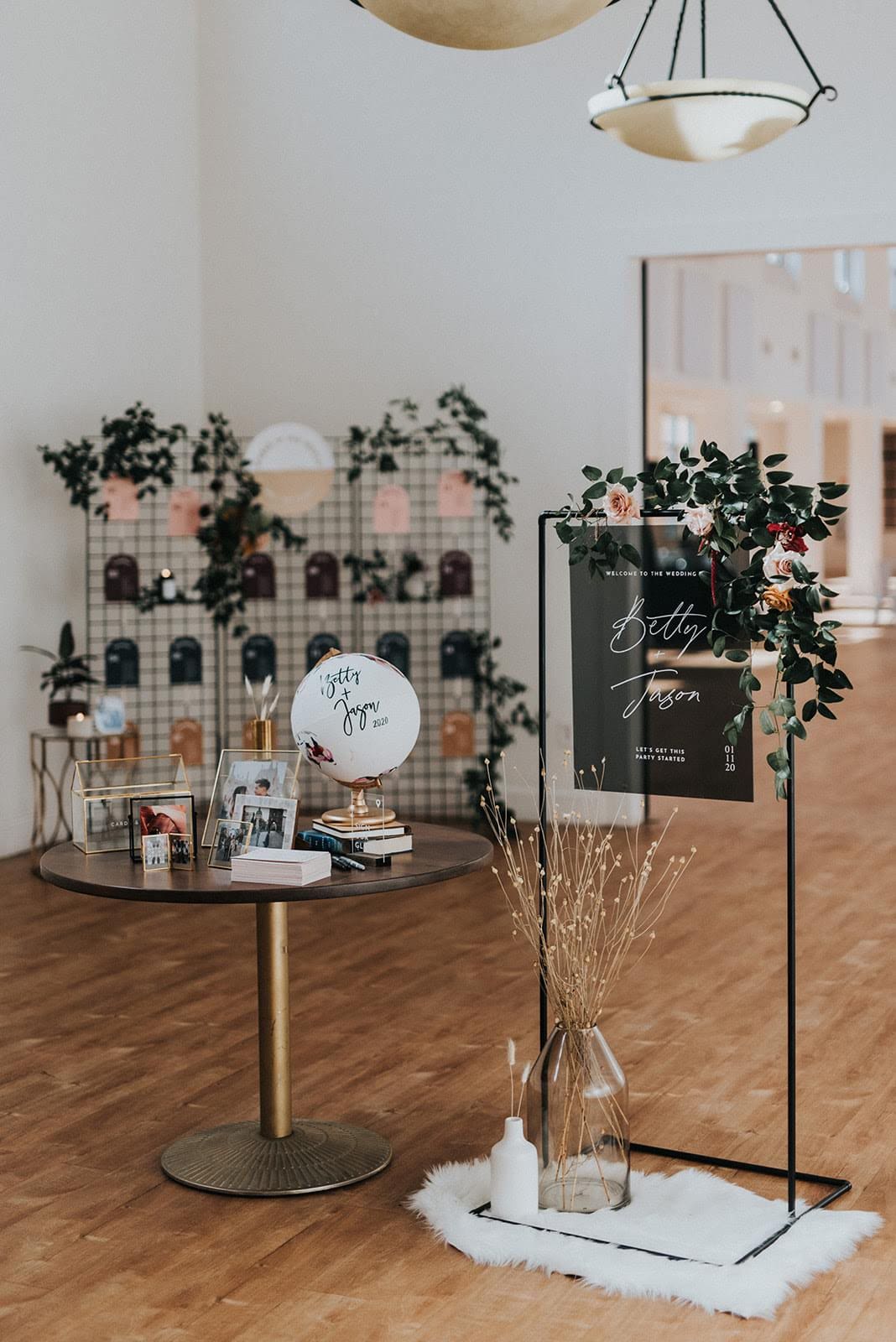 Wedding welcome scene with welcome sign, welcome table, and seating chart