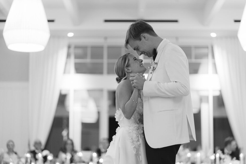 A happy wedding couple smiling on the dance floor after their ceremony, featured in a wedding vendor tipping guide to introduce thoughtful ways to show appreciation.
