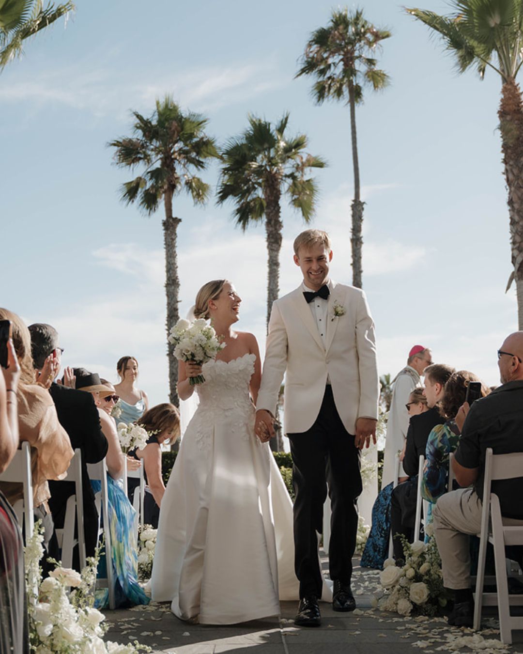 A happy wedding couple smiling after their ceremony, captured for a wedding vendor tipping guide to illustrate gratitude and celebration.